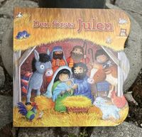 Omslag: Den första julen - flikbok
